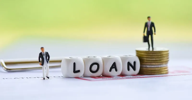Calculator and loan documents used to compare unsecured business loan rates