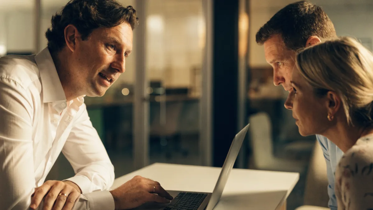 Finance broker presenting finance options to a business owner couple