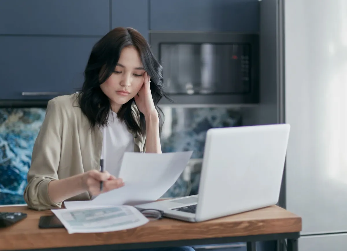 Business owners reviewing loan documents together at an office desk