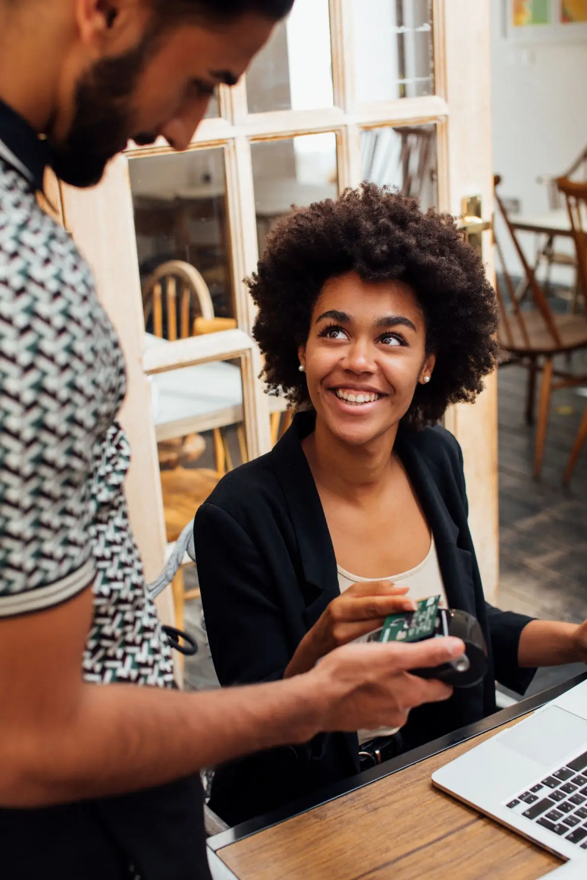 Customer paying by contactless card at a café counter
