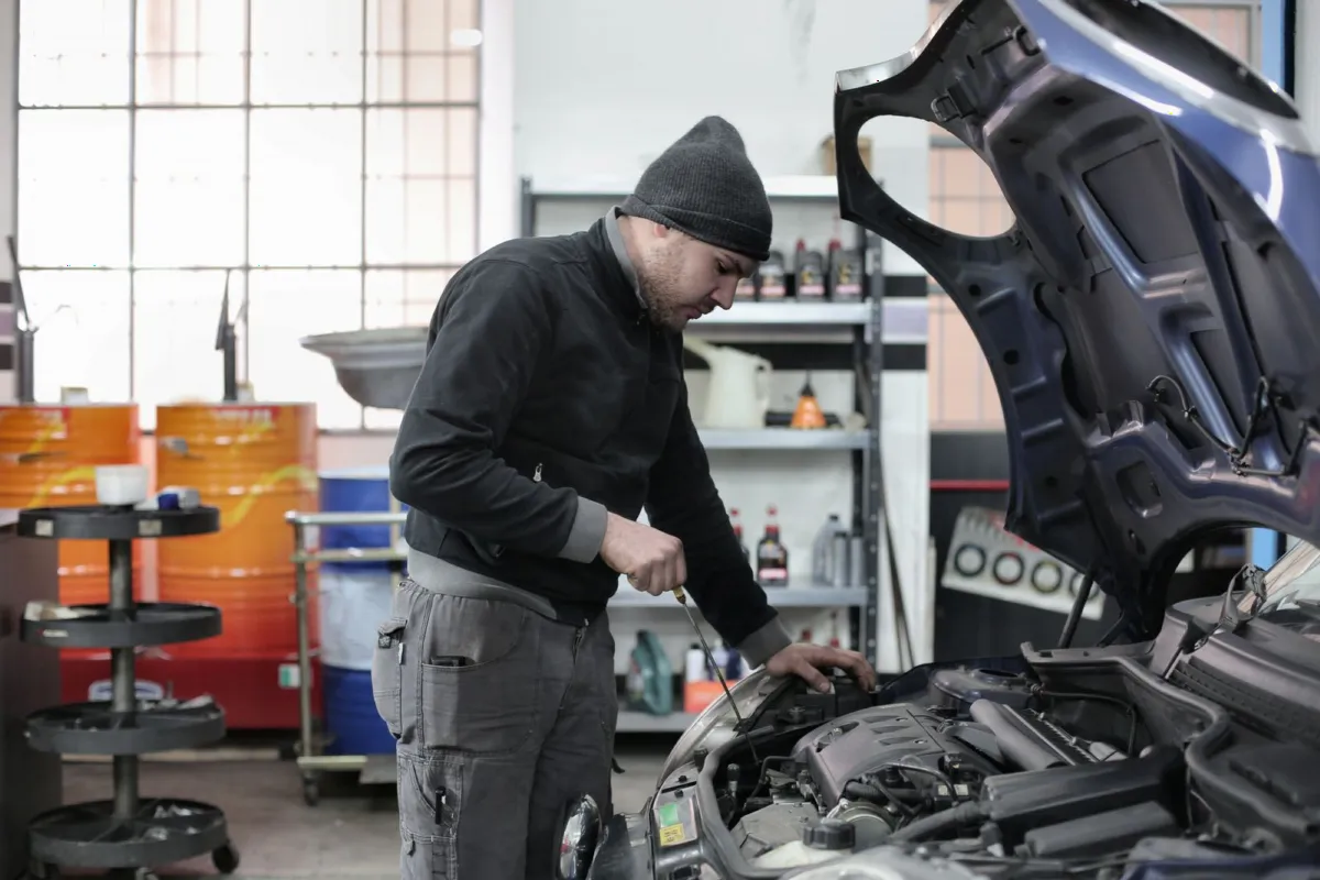Mechanic working on a car engine in a workshop